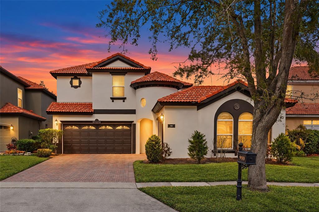 A two-story house with a terracotta tile roof, stucco exterior, and a two-car garage — 910 LASCALA DRIVE, WINDERMERE, FL