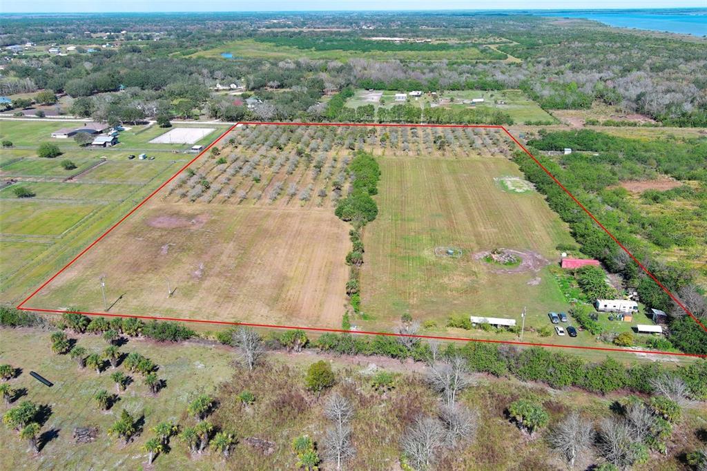 An aerial view shows a large, rectangular plot of land outlined in red with trees — 0 DAVIS ROAD, MIMS, FL