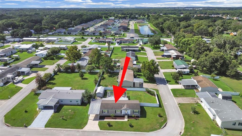 An aerial view shows a single-story house with a metal carport and a backyard pool — 490 LINDSEY DR, LAKELAND, FL