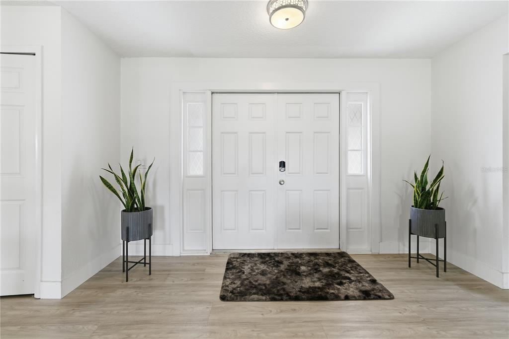 A dining room features a glass-topped table, six wooden chairs, a pendant light, and sliding doors — 1389 PONCE DE LEON BOULEVARD, WINTER SPRINGS, FL