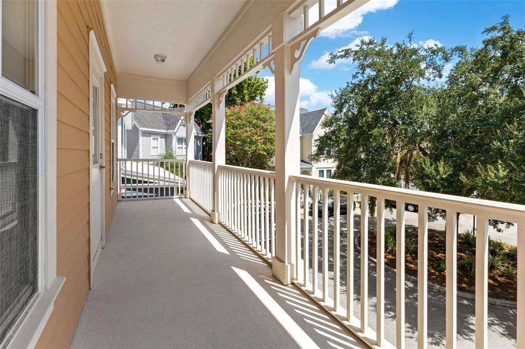 An empty room features wood-look flooring, white walls, and a single window — 1010 PERIWINKLE COURT, CELEBRATION, FL