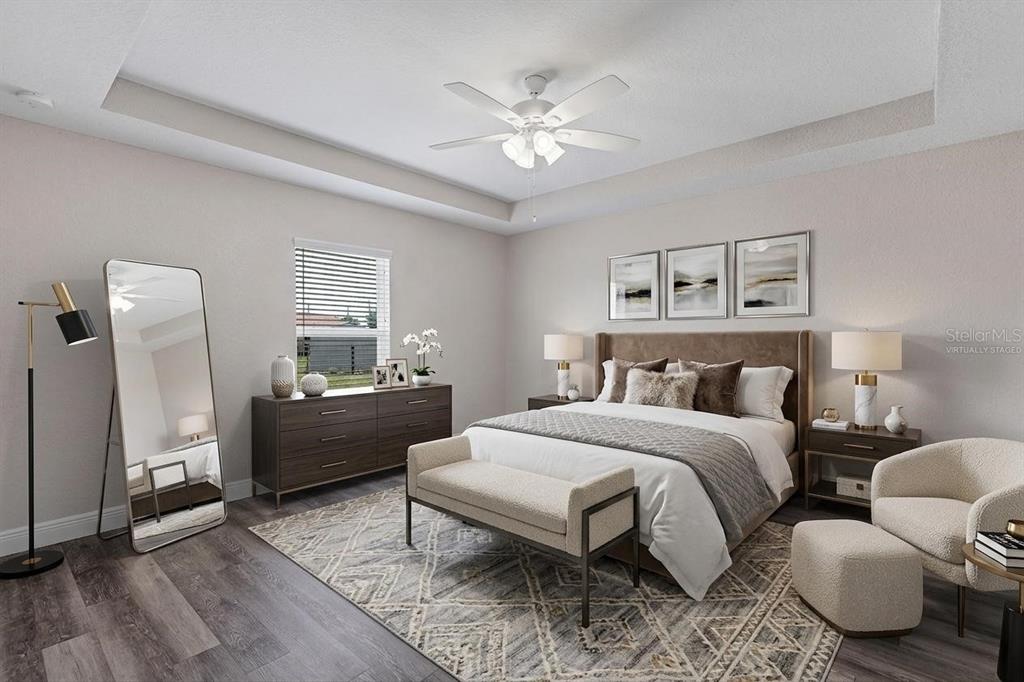 A bedroom features a bed, dresser, floor mirror, armchair, and a ceiling fan — 17 CEDAR TREE RUN, OCALA, FL
