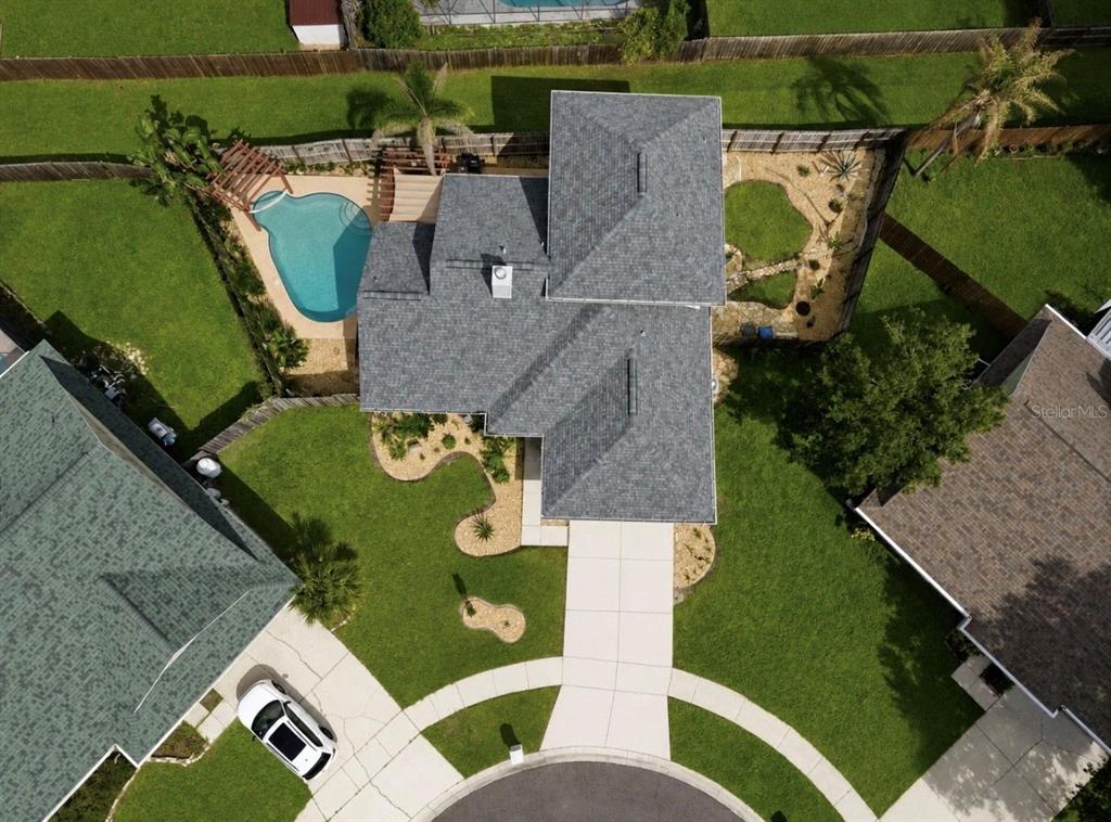 An aerial view shows a house with a gray roof, a pool, and a concrete driveway — 1921 STANFIELD DRIVE, BRANDON, FL