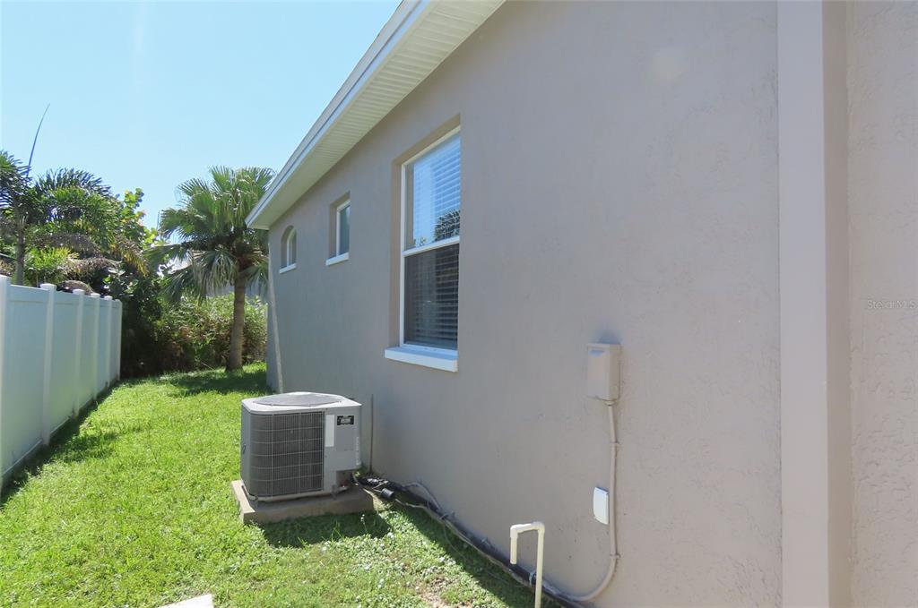 An empty room with gray walls, wood-look flooring, a ceiling fan, and an open doorway — 1801 MAPLELEAF BOULEVARD, OLDSMAR, FL