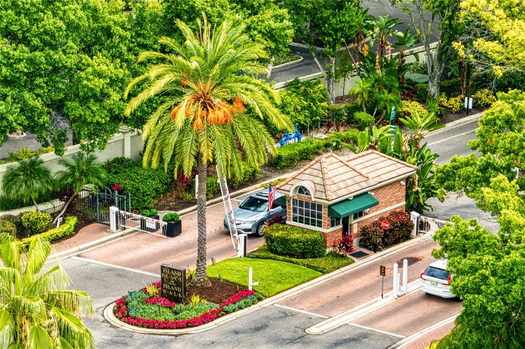 An aerial view shows a residential complex with brown roofs near a harbor and cruise ship — 919 NORMANDY TRACE ROAD, TAMPA, FL