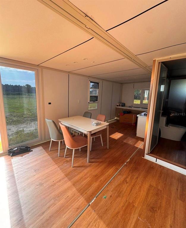 An interior view of a small living space with a dining set and wood-look flooring — 3824 STATE ROAD 33, CLERMONT, FL