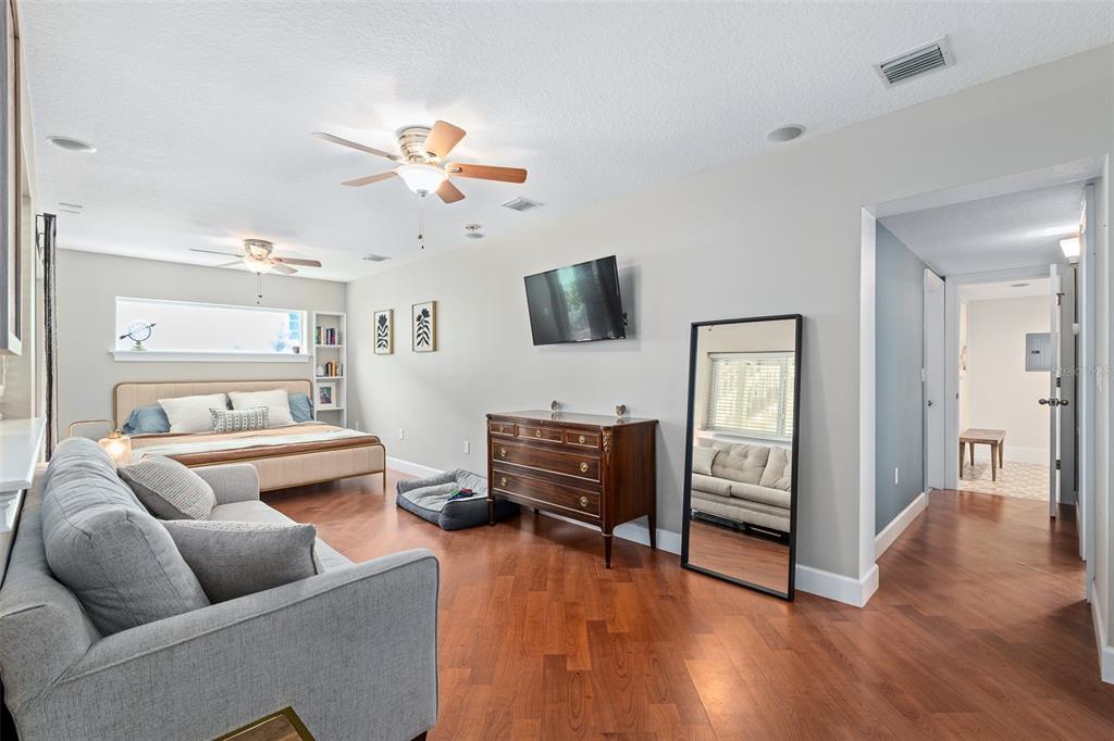 A kitchen and dining area feature light blue cabinets, stainless steel appliances, and wood flooring — 1339 S DAYTONA AVENUE, FLAGLER BEACH, FL