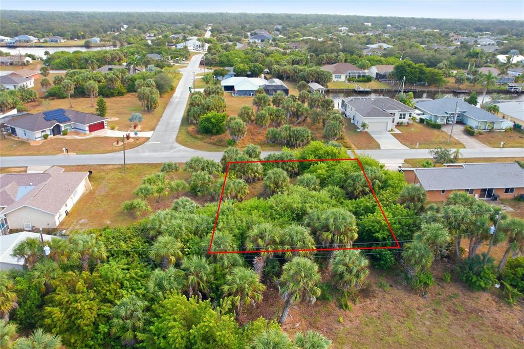 An aerial view shows a vacant, wooded residential lot outlined in red — 4081 ROSE ARBOR CIRCLE, PORT CHARLOTTE, FL