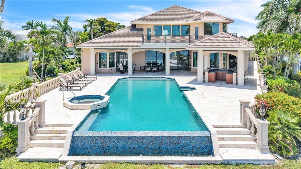 A two-story house with a tiled roof, a swimming pool, a hot tub, and patio — 3 HIBISCUS DRIVE, PUNTA GORDA, FL