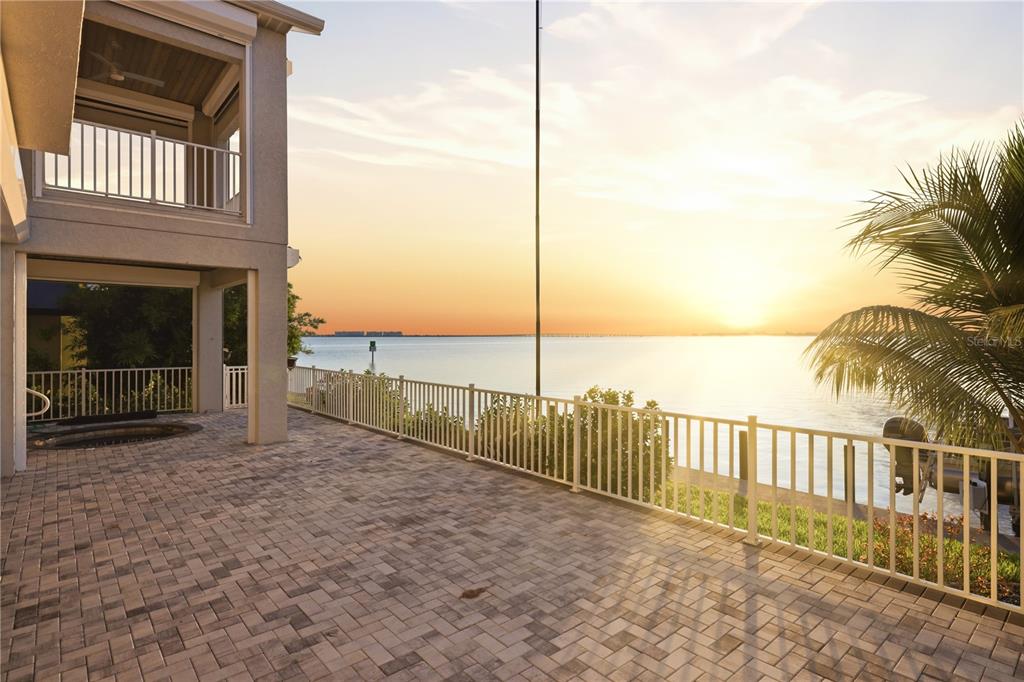 An aerial view shows a two-story waterfront house with a paved driveway and palm trees — 2139 PALM TREE DRIVE, PUNTA GORDA, FL