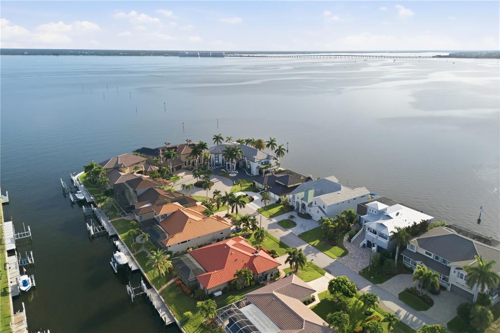 A front entrance features a double arched door, stone steps, and a white railing — 2139 PALM TREE DRIVE, PUNTA GORDA, FL