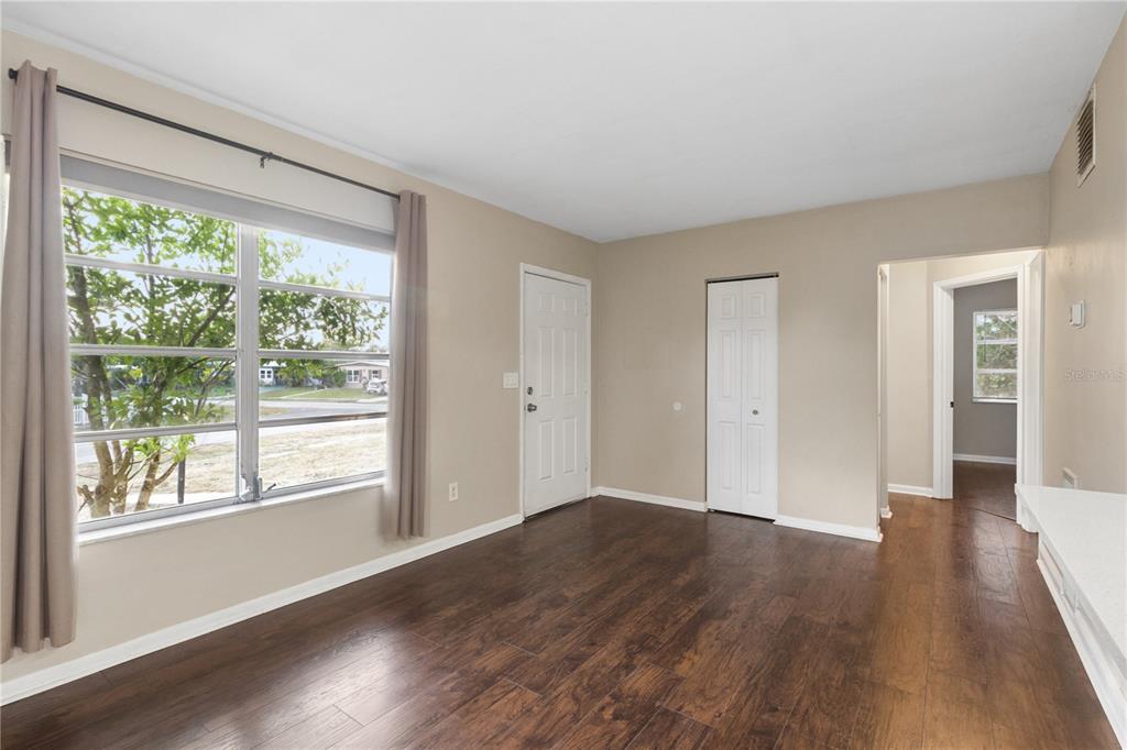 A kitchen with white cabinets, stainless steel appliances, and a white countertop peninsula — 7045 FIRESIDE STREET, SPRING HILL, FL