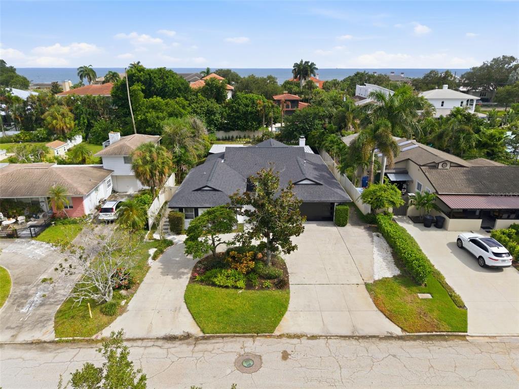 An aerial view shows a single-story house with a dark roof and a circular driveway — 219 MIRAMAR BOULEVARD NE, ST PETERSBURG, FL