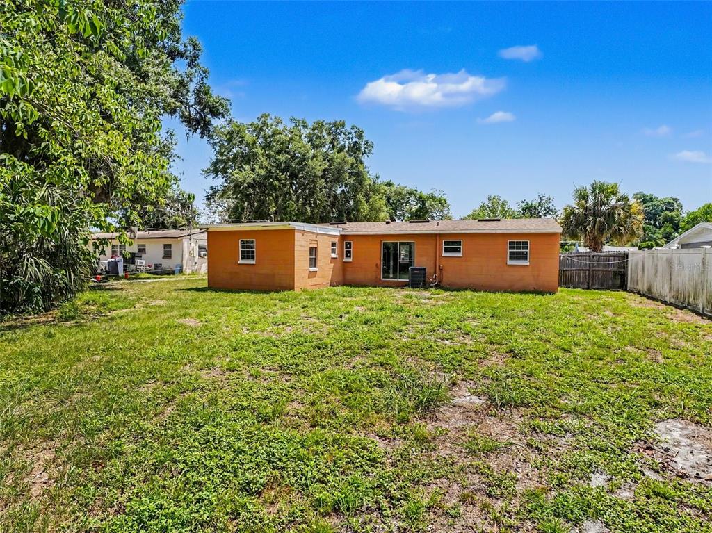 An empty room features light gray walls, tile flooring, a ceiling fan, and two windows — 4514 DREXEL AVENUE, ORLANDO, FL