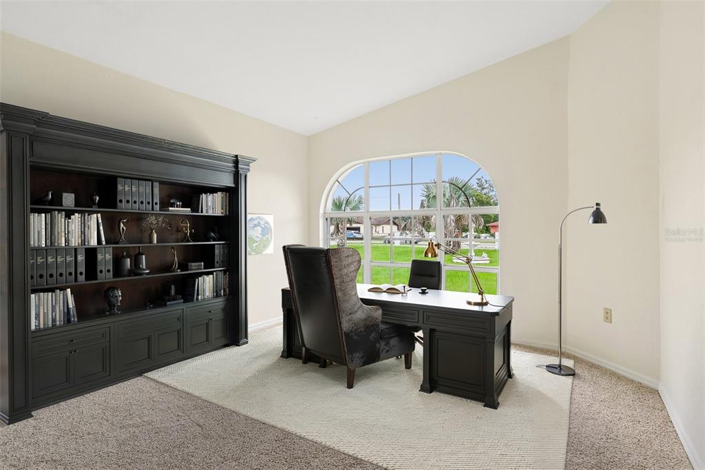 A tiled entryway features a white front door with sidelights and a chandelier above — 7026 PINEHAVEN DRIVE, LAKELAND, FL