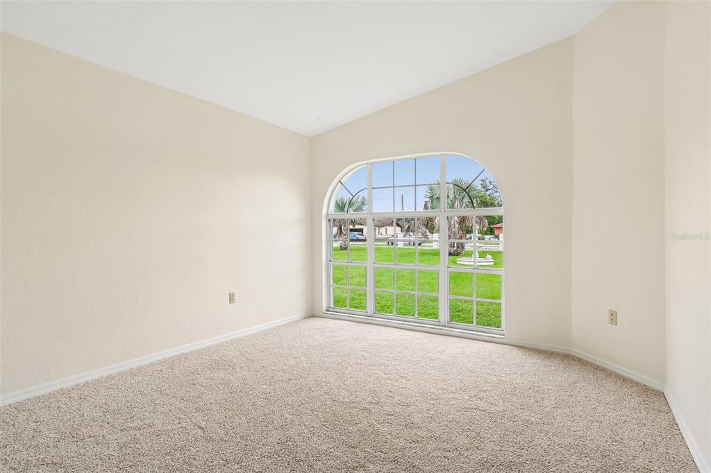 A dining room with a wooden table, upholstered chairs, and marble flooring, adjacent to a kitchen — 7026 PINEHAVEN DRIVE, LAKELAND, FL