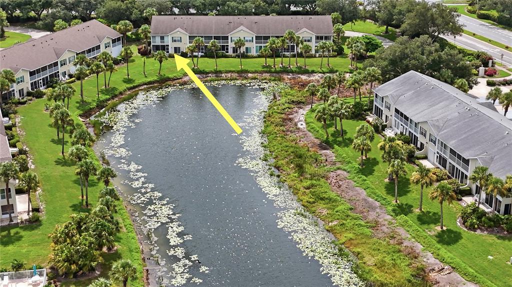 A kitchen features white cabinets, stainless steel appliances, granite countertops, and light tile flooring — 418 LAUREL LAKE DRIVE UNIT 106, VENICE, FL