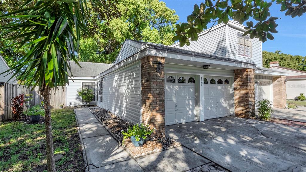 A two-story house with a brick and siding exterior features a two-car garage — 2820 RISSER AVENUE, ORLANDO, FL