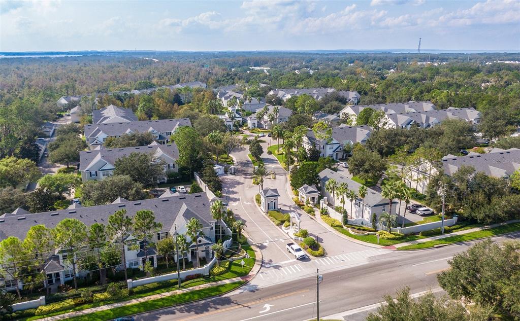 An aerial view of a gated residential community with multi-story apartment buildings and lush landscaping — 213 SOUTHERN PECAN CIRCLE UNIT 201, WINTER GARDEN, FL