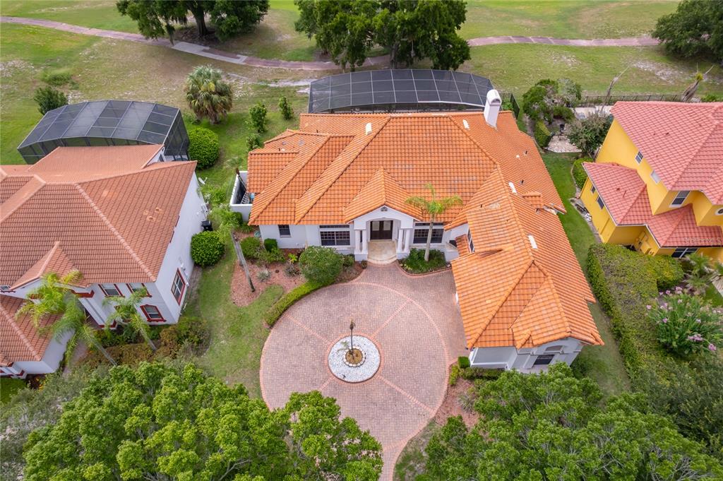 An aerial view shows a house with a terracotta tile roof and a circular driveway — 2313 ROAT DRIVE, ORLANDO, FL