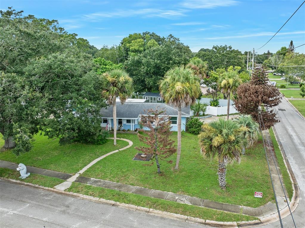 An aerial view shows a single-story house with a blue exterior, palm trees, and lawn — 700 KATHERINE STREET, SOUTH DAYTONA, FL
