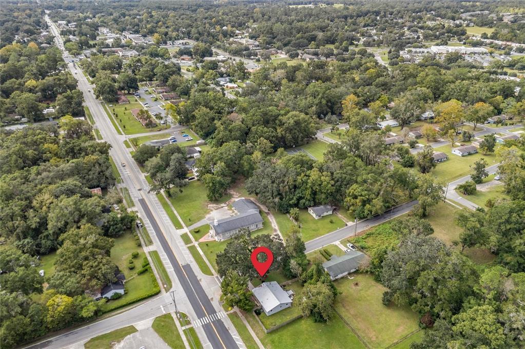 An aerial view shows a single-story house with a red location pin on its roof — 14004 NW 158TH AVENUE, ALACHUA, FL