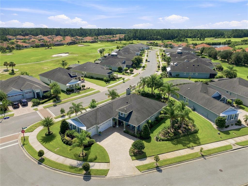 An aerial view of a suburban neighborhood featuring single-family homes, paved streets, and a golf course — 2811 SIENNA VIEW TERRACE COURT, NEW SMYRNA BEACH, FL