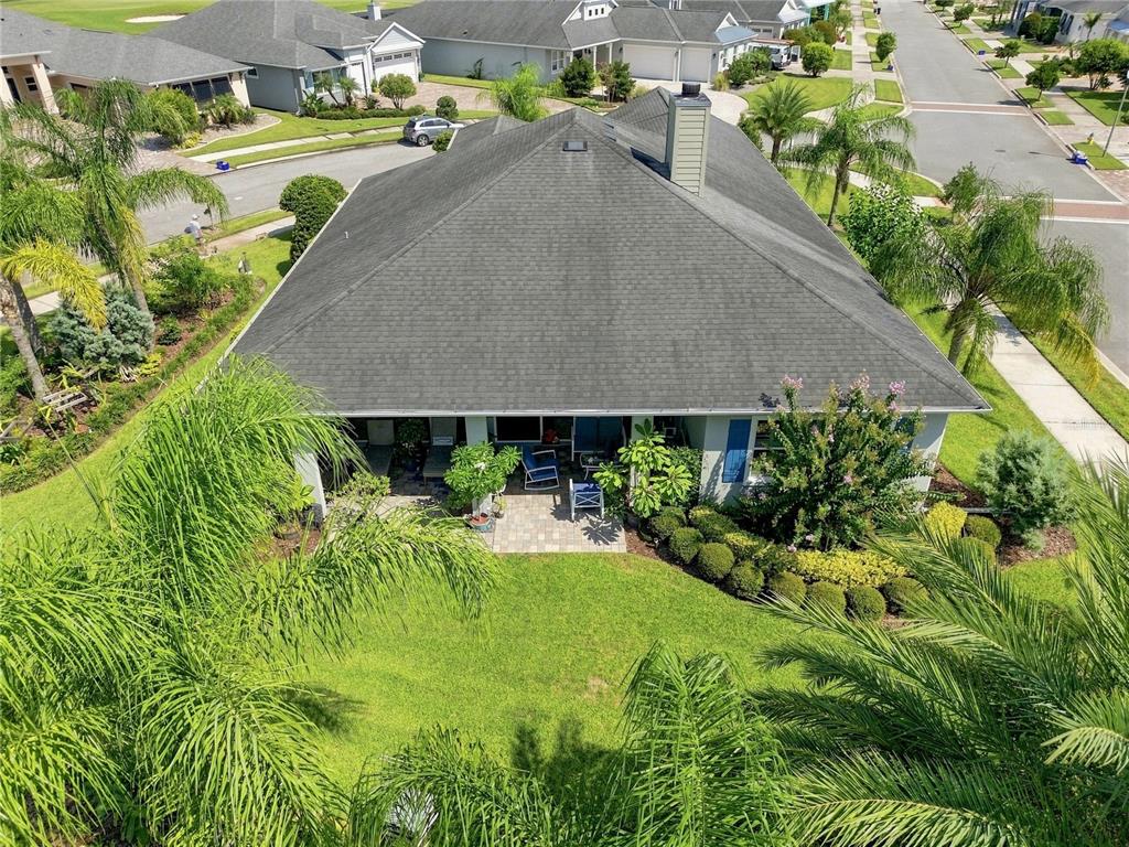 An aerial view shows the back of a house with a patio and landscaped yard — 2811 SIENNA VIEW TERRACE COURT, NEW SMYRNA BEACH, FL