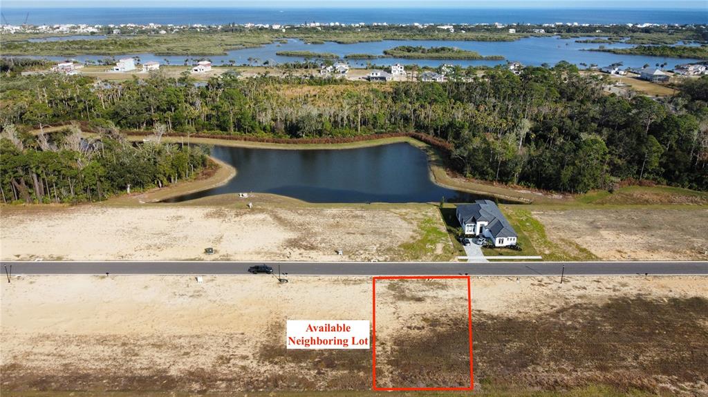 An aerial view shows a vacant, rectangular lot outlined in red along a paved road — 197 STILLWATER DRIVE, FLAGLER BEACH, FL