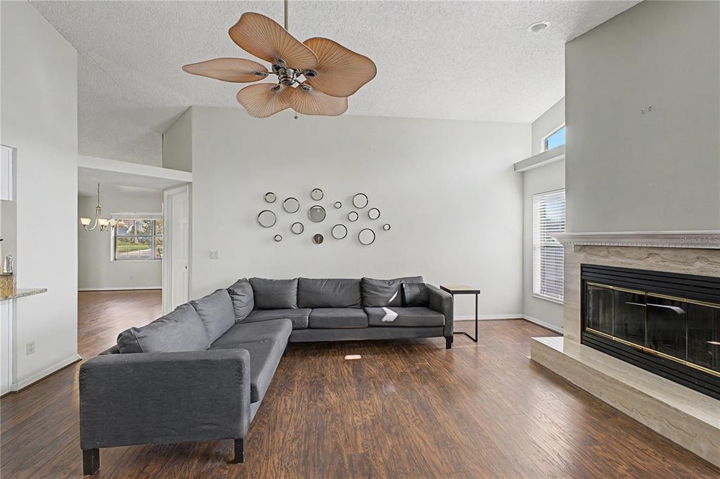 A single-story house with a beige exterior, a two-car garage, and a large front tree — 1364 OVERLAND DRIVE, SPRING HILL, FL