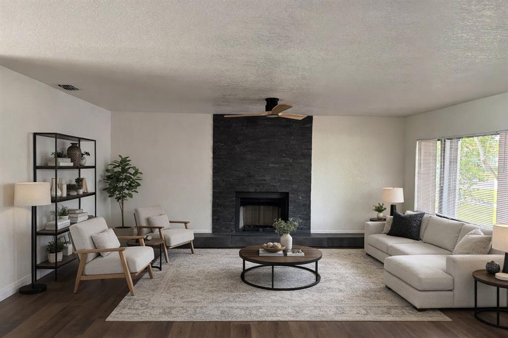 A living room features a black stone fireplace, light-colored furniture, and a round coffee table — 343 SHORE DRIVE E, OLDSMAR, FL