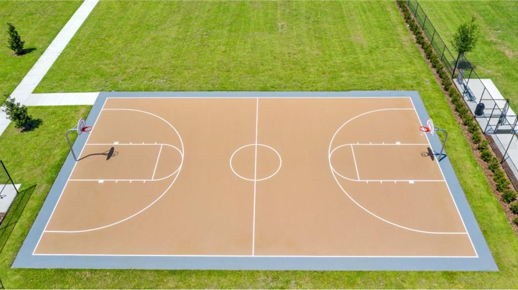 An aerial view of an outdoor basketball court with a tan surface and white markings — 5784 ENERGY WAY, CLERMONT, FL