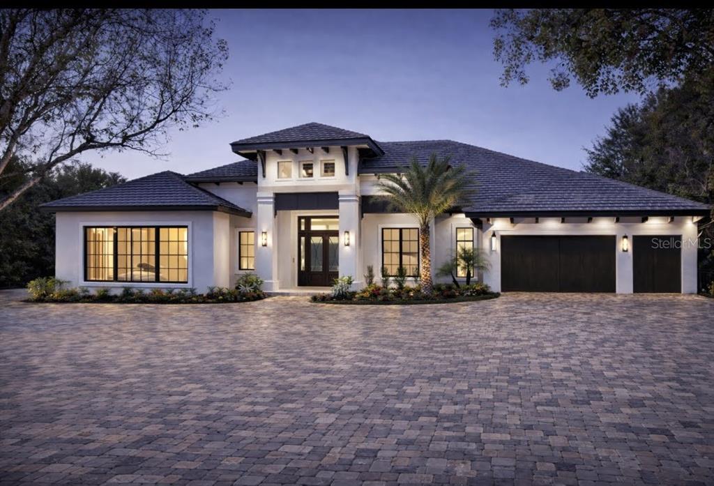 A modern single-story house with a paved driveway, dark roof, and white stucco exterior — 0 ROBERTS RD. ROAD, NOKOMIS, FL