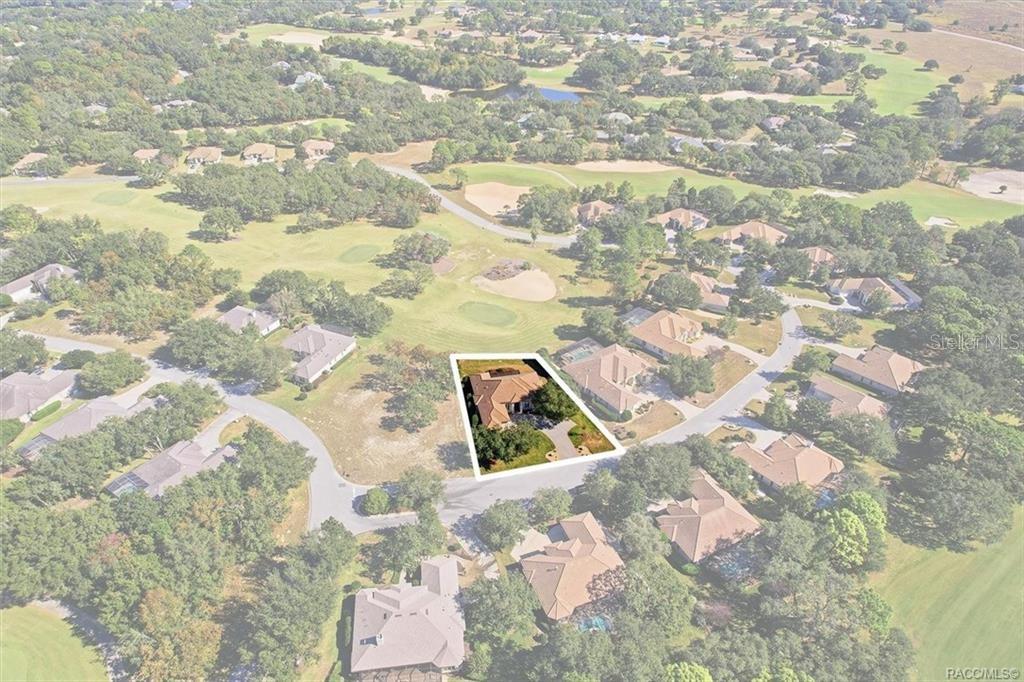 An aerial view shows a single-family home highlighted on a lot within a golf course community — 2618 N CARNOUSTIE LOOP, LECANTO, FL