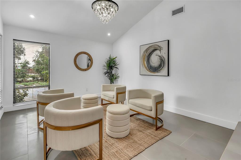 A modern entryway features a large arched mirror, a console table, and wall-mounted woven baskets — 3033 WISTER CIRCLE, VALRICO, FL