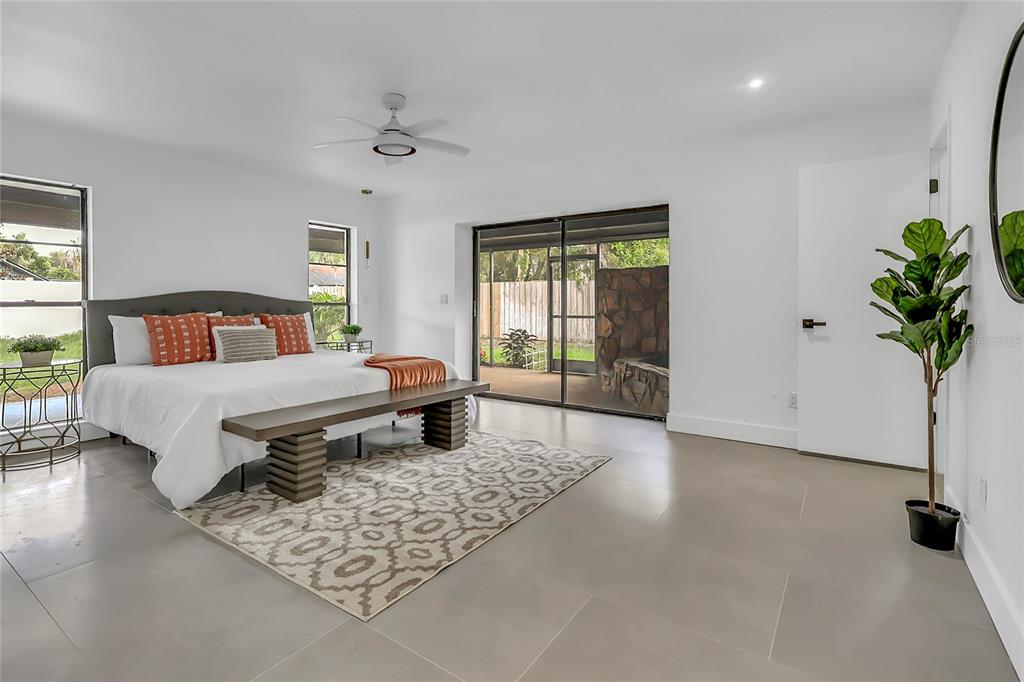 A living room features a stone fireplace, four curved white chairs, and a crystal chandelier — 3033 WISTER CIRCLE, VALRICO, FL