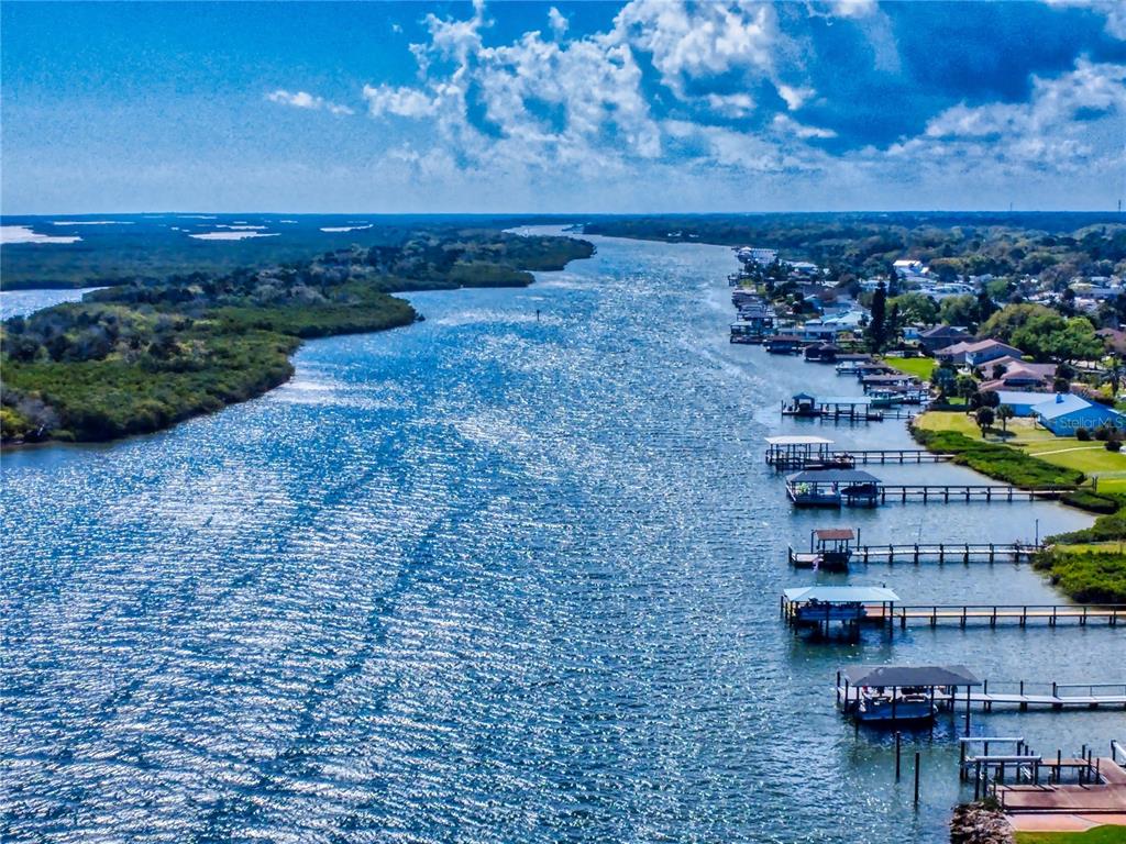 An aerial view shows a waterway lined with residential docks and houses along the shore — 2019 S RIVERSIDE, EDGEWATER, FL