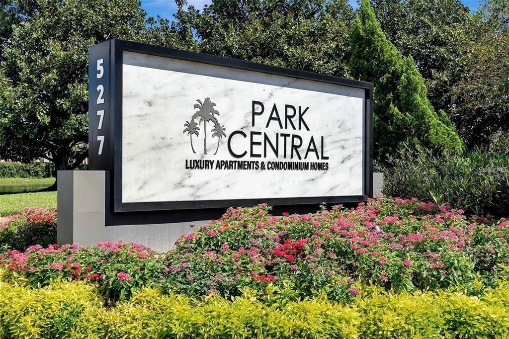 A sign for Park Central luxury apartments and condominium homes stands in a landscaped garden — 5005 CITY STREET UNIT 1335, ORLANDO, FL