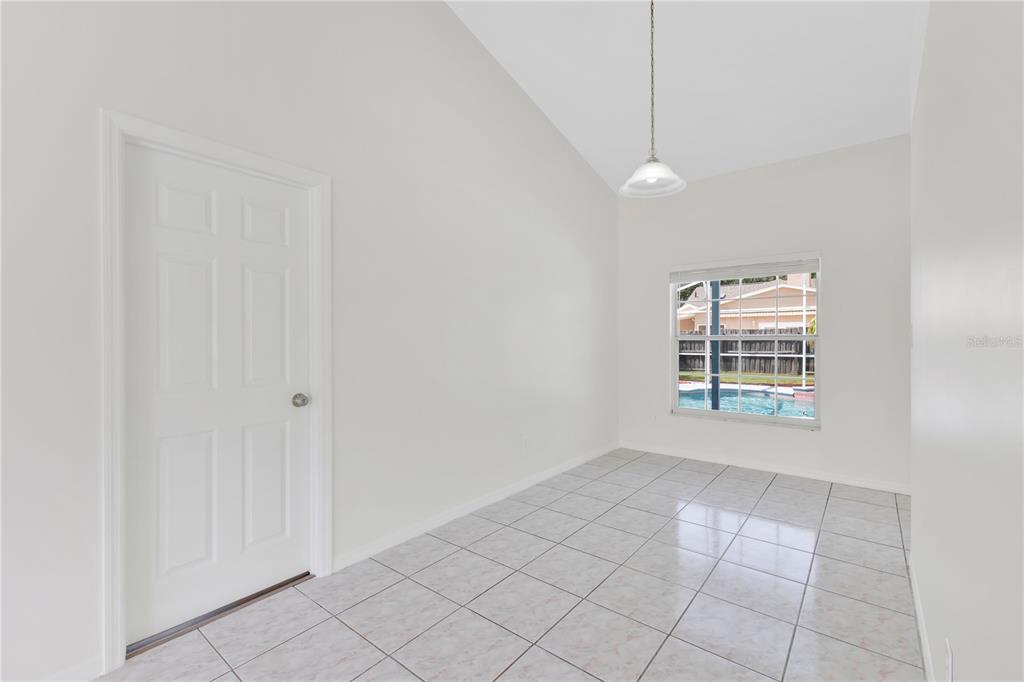A room with white walls, tiled flooring, a single door, and a window overlooking a pool — 1097 DEPOT COURT, WINTER GARDEN, FL