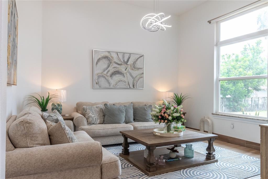 A living room features a beige sofa, a wooden coffee table, and a patterned area rug — 2815 2815 DAIRY RD, MELBOURNE, FL