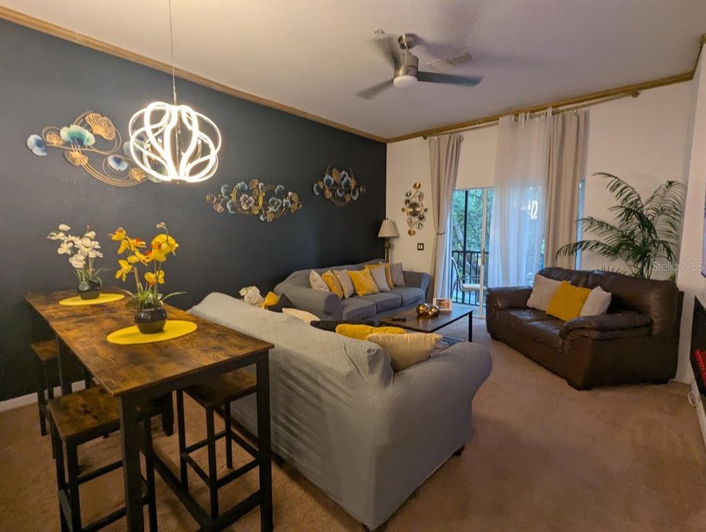 A sandy beach area features palm trees, thatched-roof umbrellas, and rows of blue lounge chairs — 510 RUM RUN UNIT 510, DAVENPORT, FL