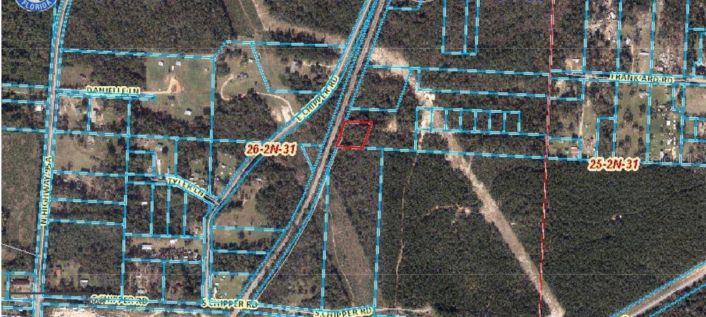 This is an aerial map showing a highlighted parcel of land near a highway — S CHIPPER ROAD, CANTONMENT, FL