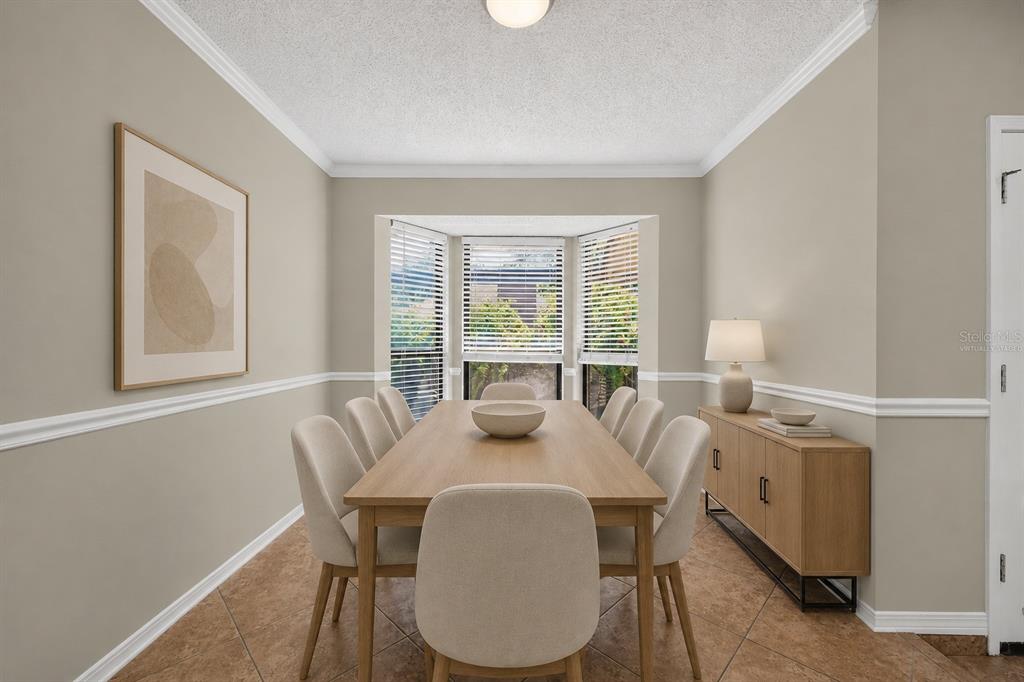 A dining room features a wooden table with six chairs, a sideboard, and tile flooring — 3080 MARRANO DRIVE, ORANGE PARK, FL