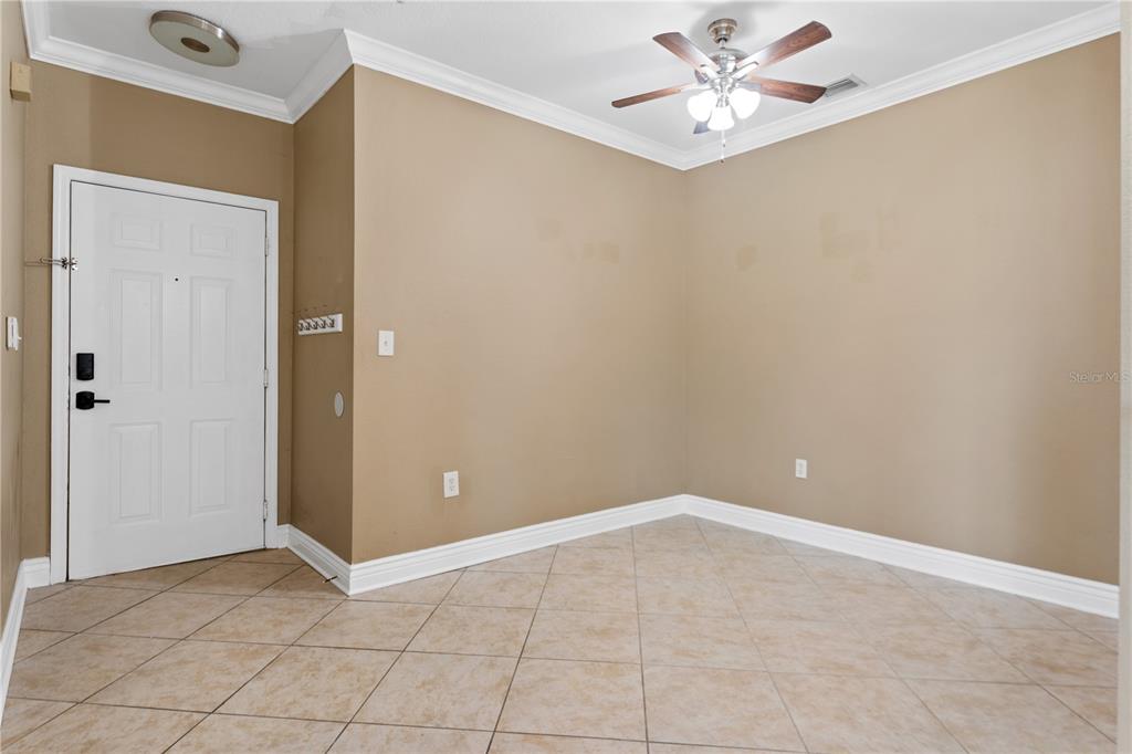 A view from a balcony overlooking the exterior of a multi-story Mediterranean-style apartment building — 2717 VIA CIPRIANI UNIT 631A, CLEARWATER, FL