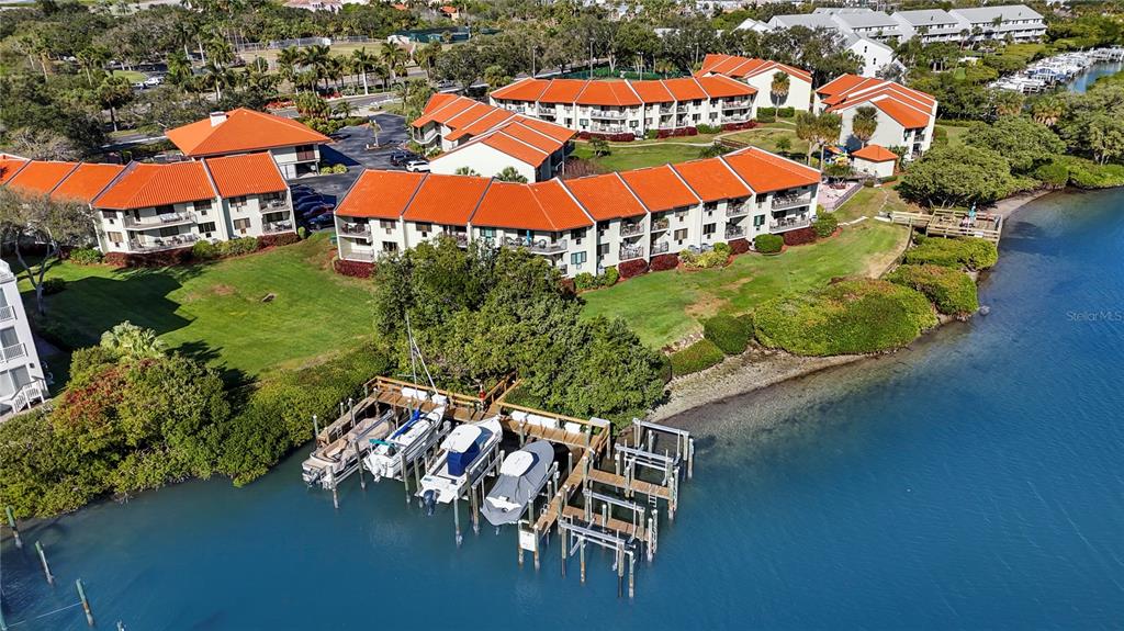 A covered balcony with a metal railing overlooks a body of water — 1515 PINELLAS BAYWAY S UNIT 7, TIERRA VERDE, FL