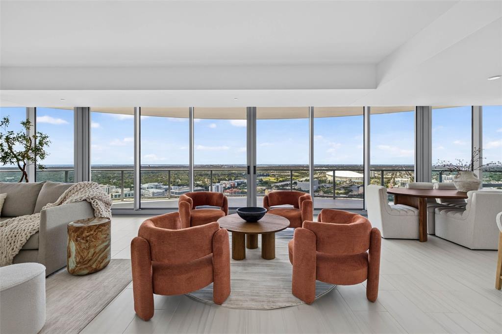 A modern kitchen features white upper cabinets, wood-tone lower cabinets, and a gray island countertop — 400 CENTRAL AVENUE UNIT 3401, ST PETERSBURG, FL