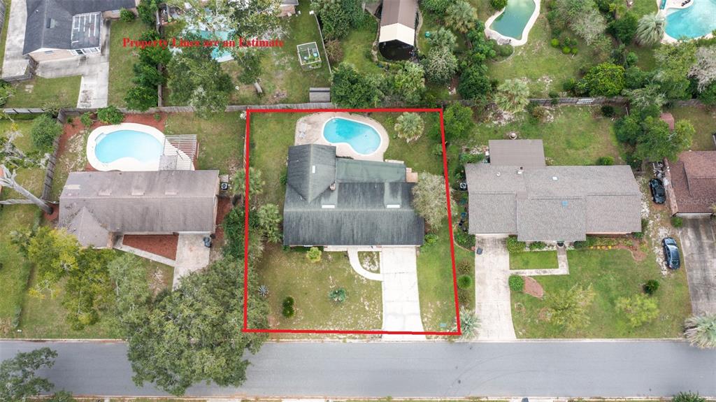 An aerial view shows a single-story house with a swimming pool and driveway — 3442 RED OAK CIRCLE E, ORANGE PARK, FL