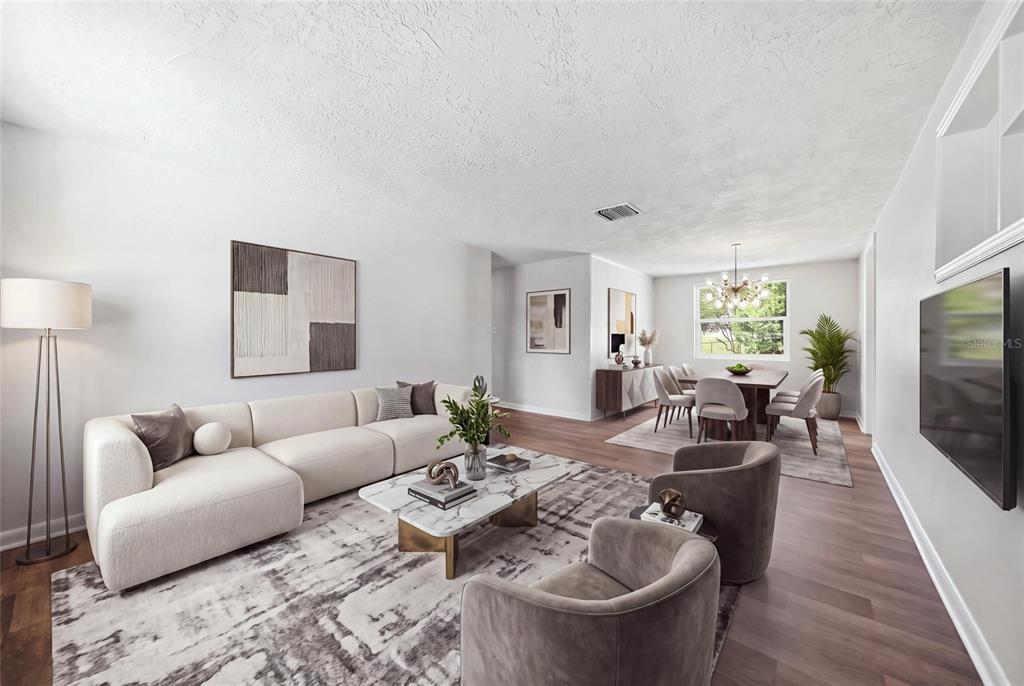 A modern living and dining room with light wood floors, a white sofa, and armchairs — 52 S JEFFERSON STREET, BEVERLY HILLS, FL