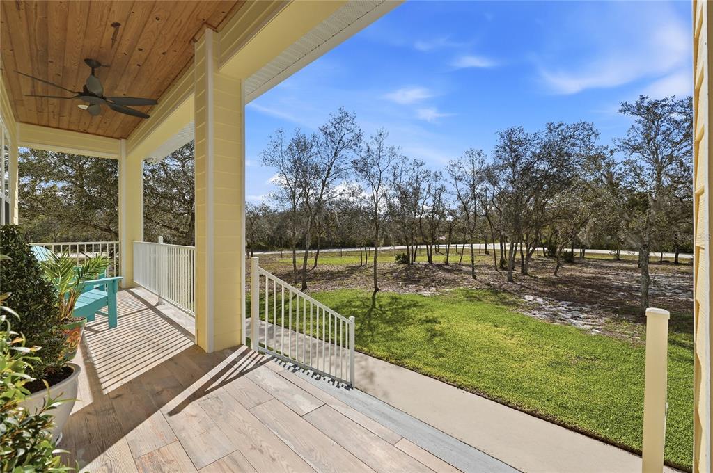 A bedroom with a bed, desk, chair, and French doors leading to an outdoor patio — 2204 R E BYRD ROAD, FROSTPROOF, FL