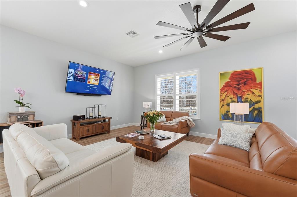A modern kitchen features white cabinets, black granite countertops, a center island, and stainless appliances — 2204 R E BYRD ROAD, FROSTPROOF, FL